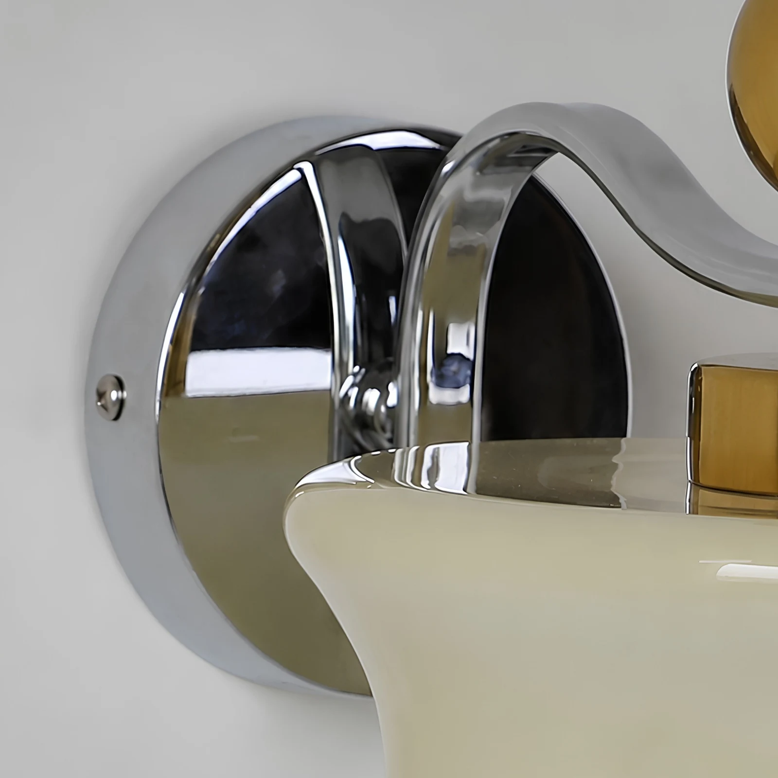 Chrome round wall plate and curved arm detail