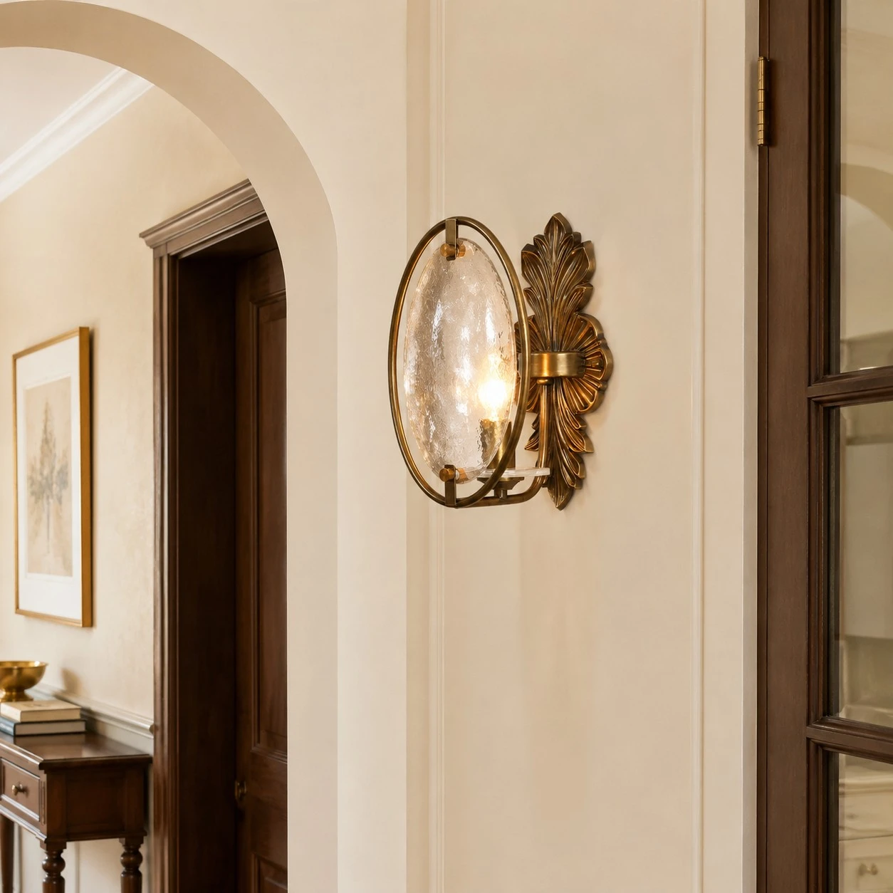 Antique brass glass wall sconce installed in a hallway