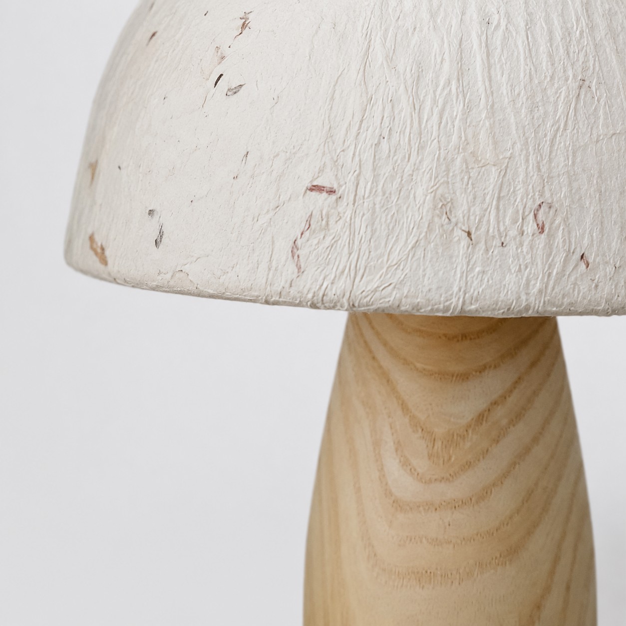 Paper shade and natural wood base close-up